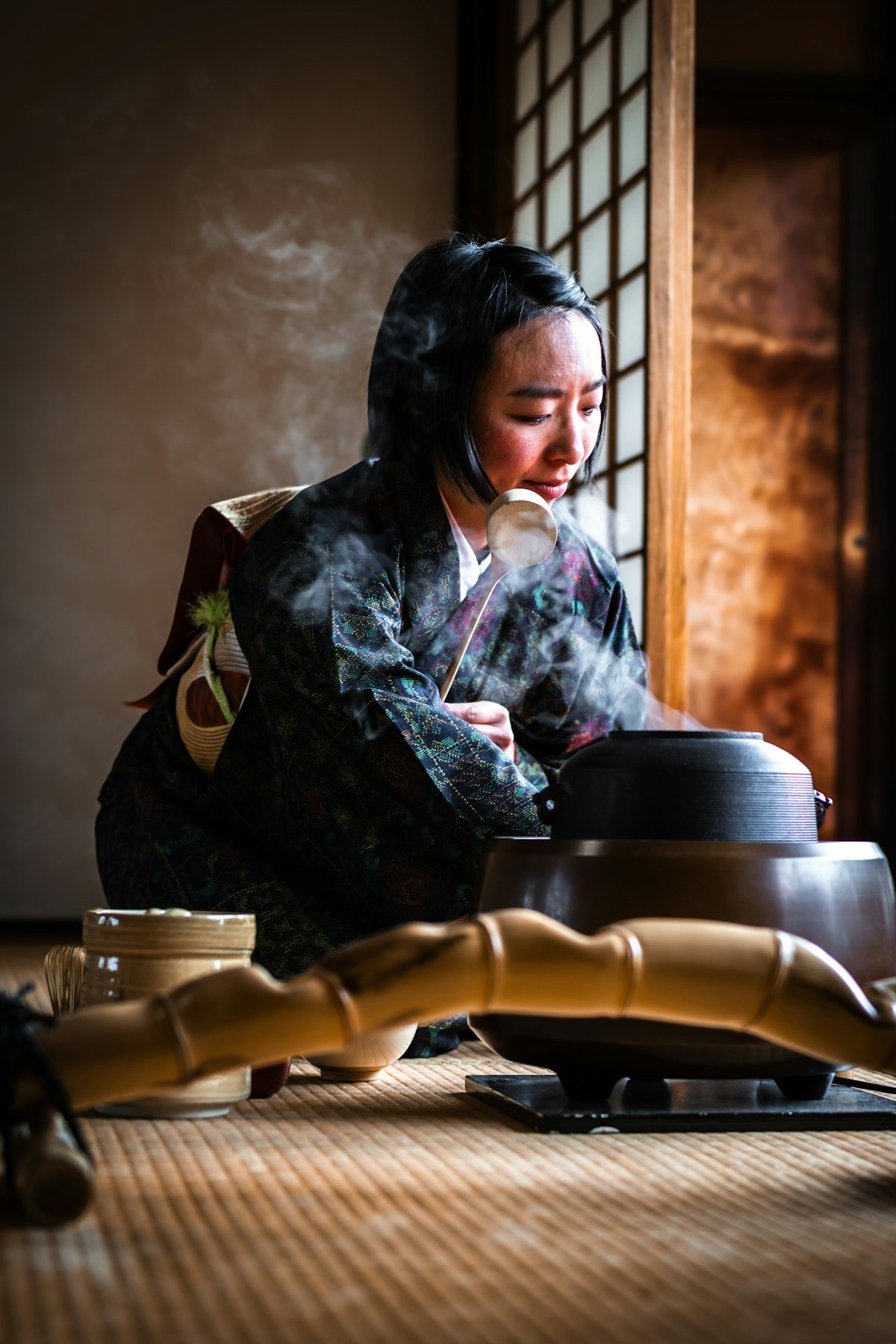 ichigo ichie meaning — a woman performing the traditional Japanese tea ceremony in a serene, intimate setting