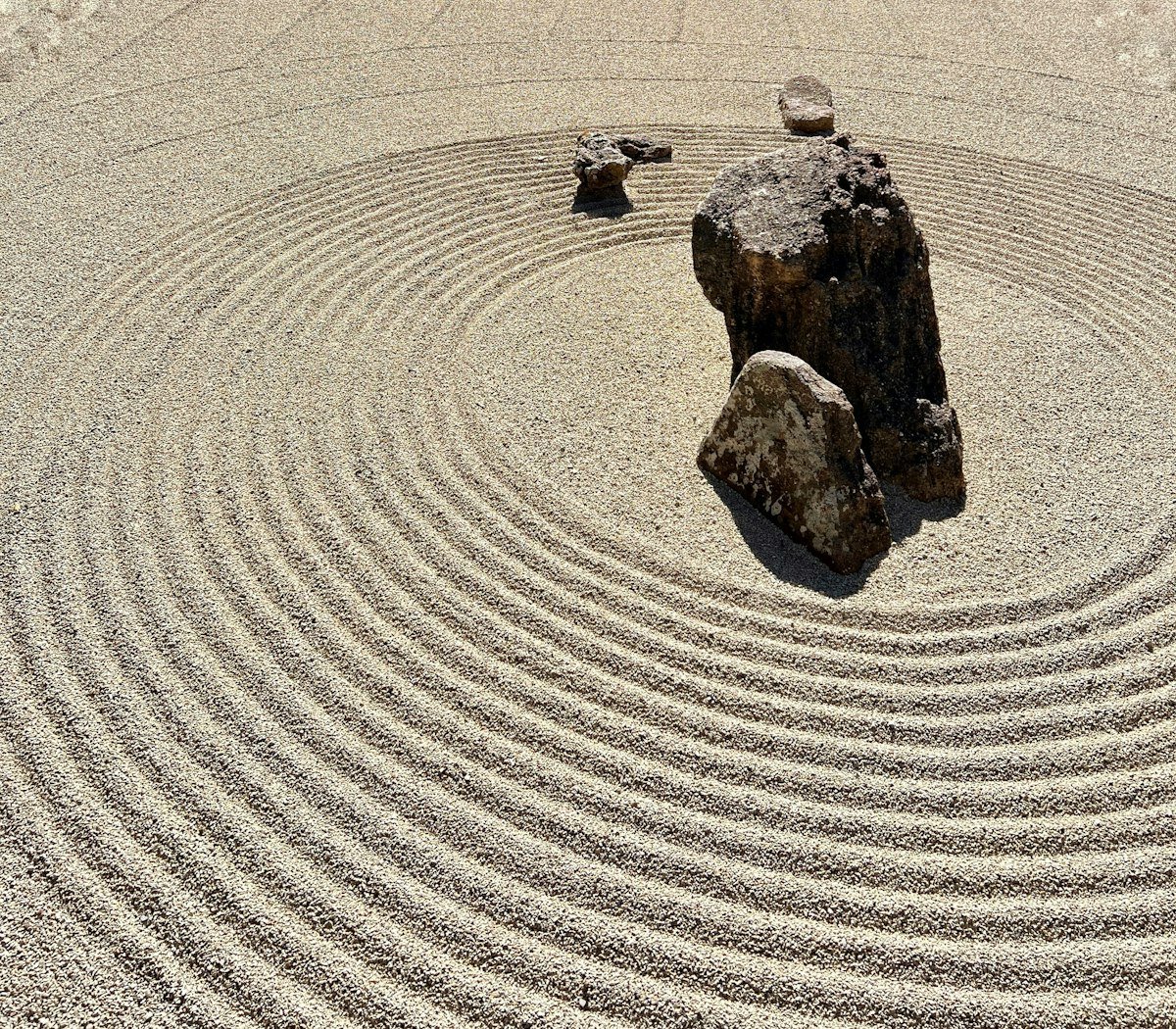 ma meaning — Japanese zen garden with rock in sand circle representing negative space