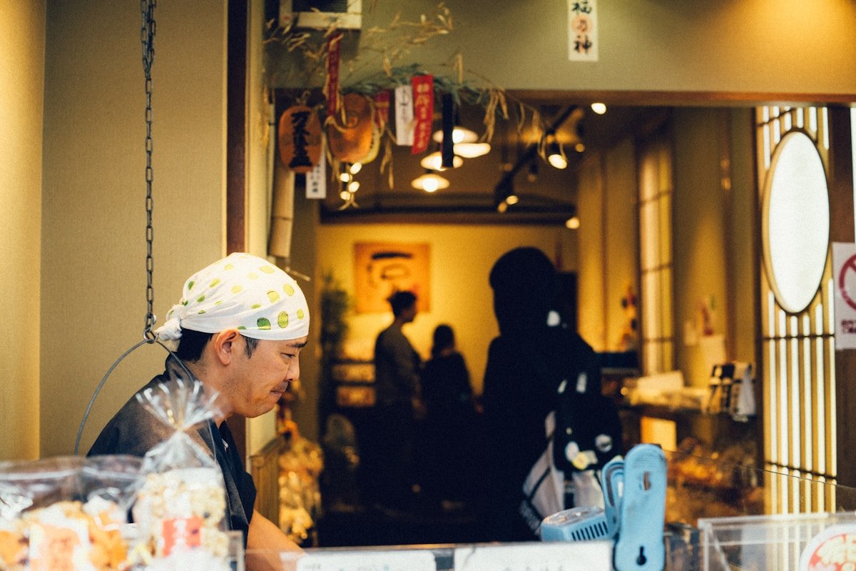 shokunin meaning — craftsman chef preparing food at a restaurant counter in Kyoto Japan